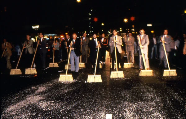 Image: theartblog.org. Mierle Laderman Ukeles, Sanitation Celebrations Grand Finale of the First NYC Art Parade, Part III: Ceremonial Sweep, 1983. Sanitation and union executives and municipal, arts, and cultural leaders clean the entire parade route along with the artist and her family. Courtesy of Ronald Feldman Fine Arts. Photo: Paula Court.