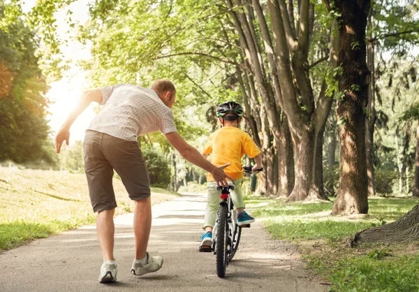father_teaching_son_to_ride_bike.jpg