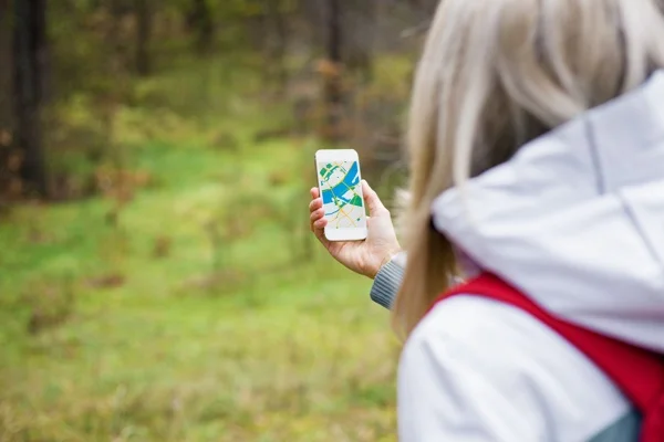 woman_walking_in_woods_geocache.jpg