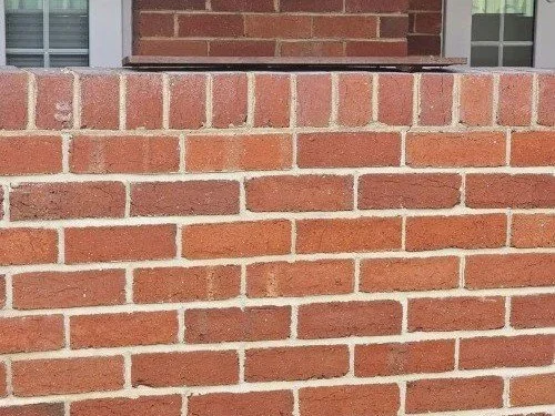 brick wall after mortar repairs and pointing