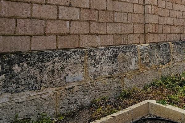 limestone at base of brick wall that needs restoring