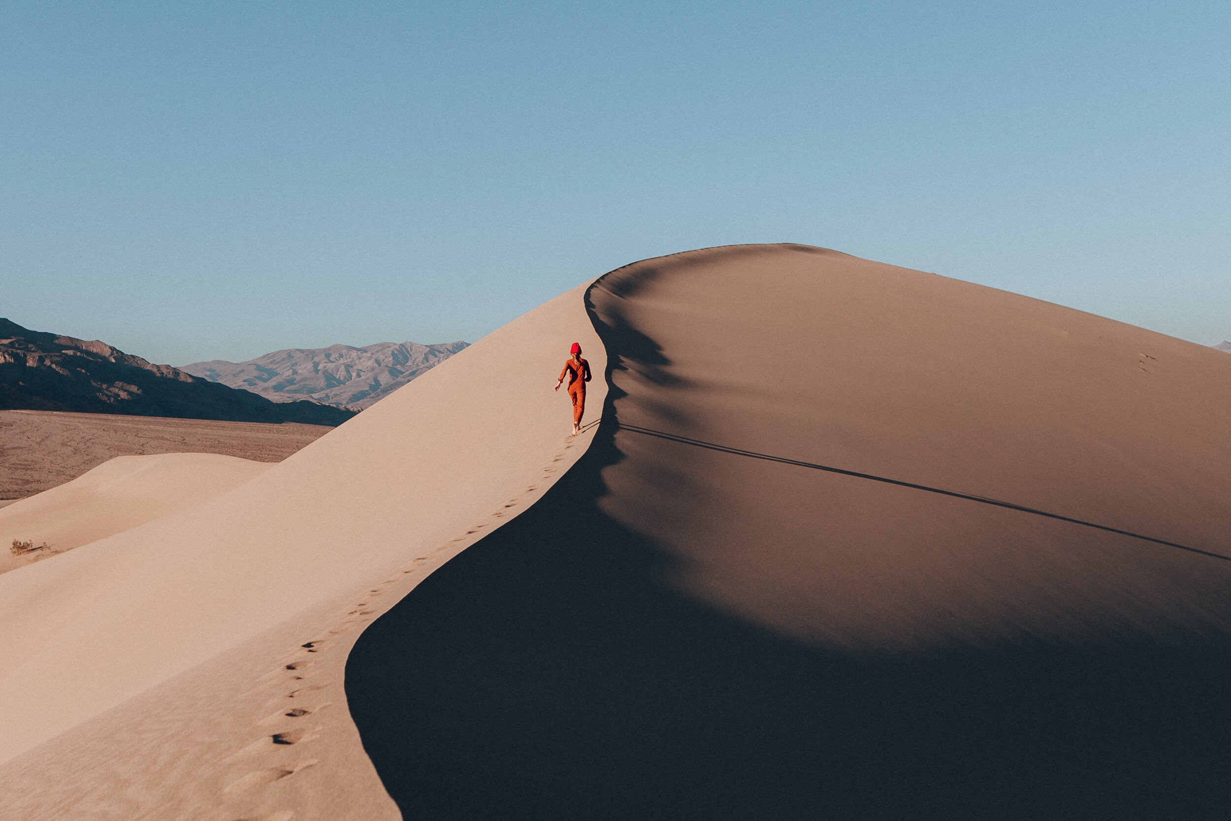 topo-girl-running-sand-dunes.JPG