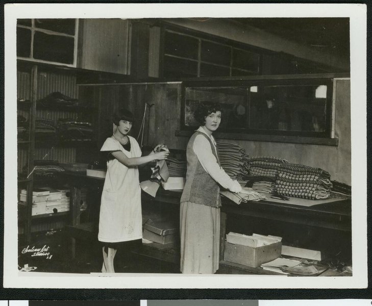  Two women folding garments in a Los Angeles clothing factory, ca.1928 