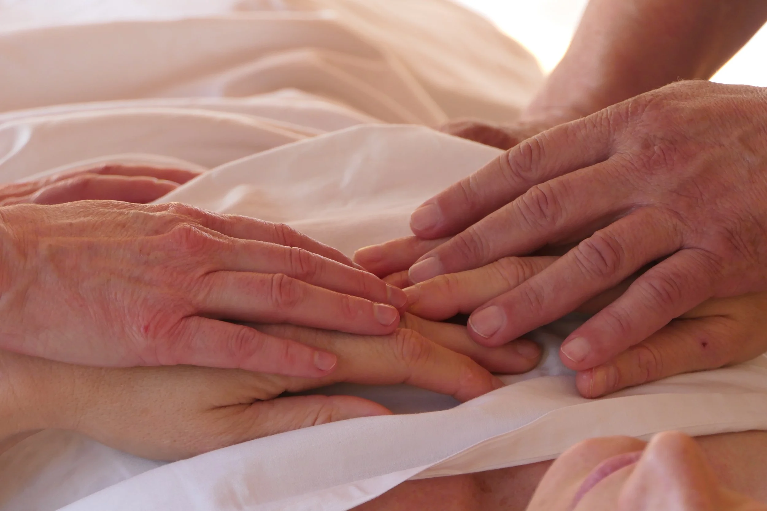 Hands holding space and body in Esalen Massage