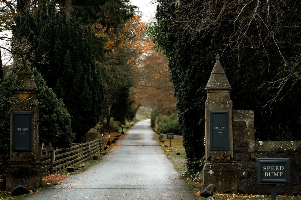 two stone pillars either side of a narrow road leading to cornhill castle lodges in biggar lanarkshire scotland