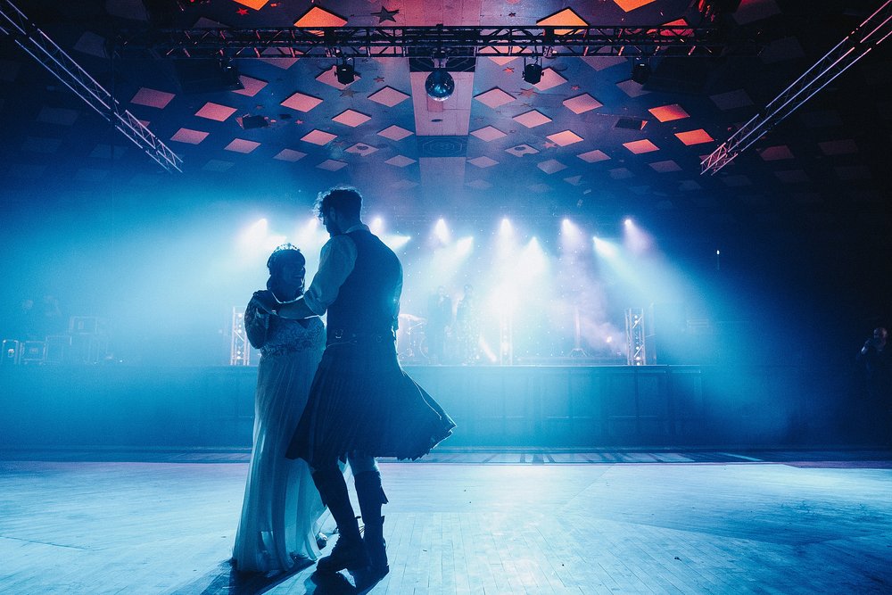bride and groom during their first dance under the blue stage lights inside barrowlands which is a diy wedding venue scotland