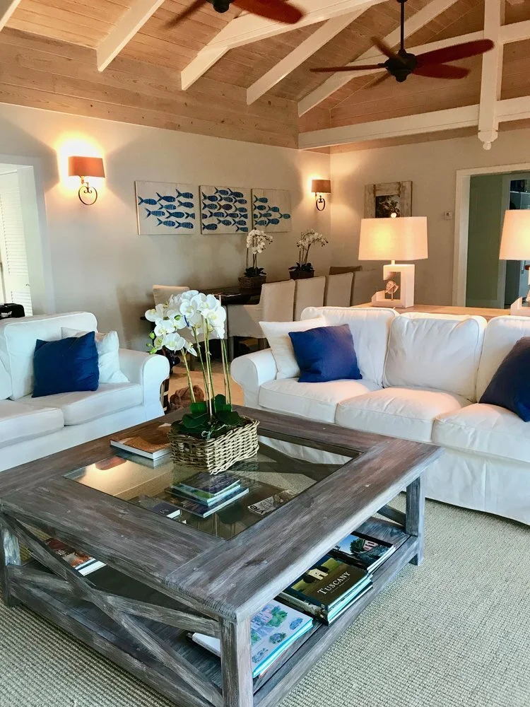 Clean white slipcovered sofas with deep blue pillows. The painting of the school of the fish over the dining was so graphic and whimsical.