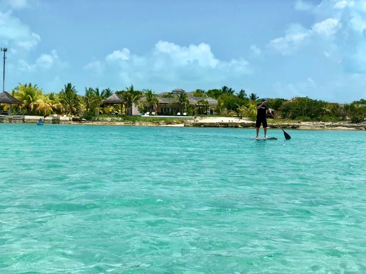 Great pic of my brother Trey- paddle boarding in front of the house. I was just hanging out in my kayak talking with him, while taking this pic.