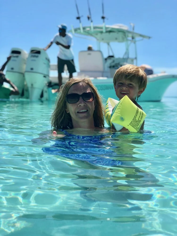 My Mom &amp; Ryder playing in the water. In the background, you can see our guide &amp; the boat. If you are planning to go to the Exumas, you MUST hire&nbsp;Theo Gray&nbsp;and his son Junior to take you out to explore the island. They felt like old…