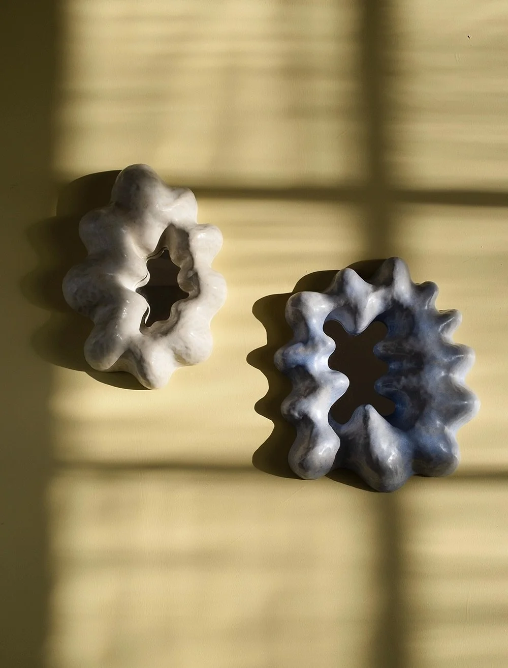 Two sculptural mirrors made exclusively for @finelittleday 

Hand built in white stoneware and finished off with a silky matte off-white glaze and the other one in a semi-matte sky blue glaze. With its cloud like shape, this ceramic mirror adds a pla