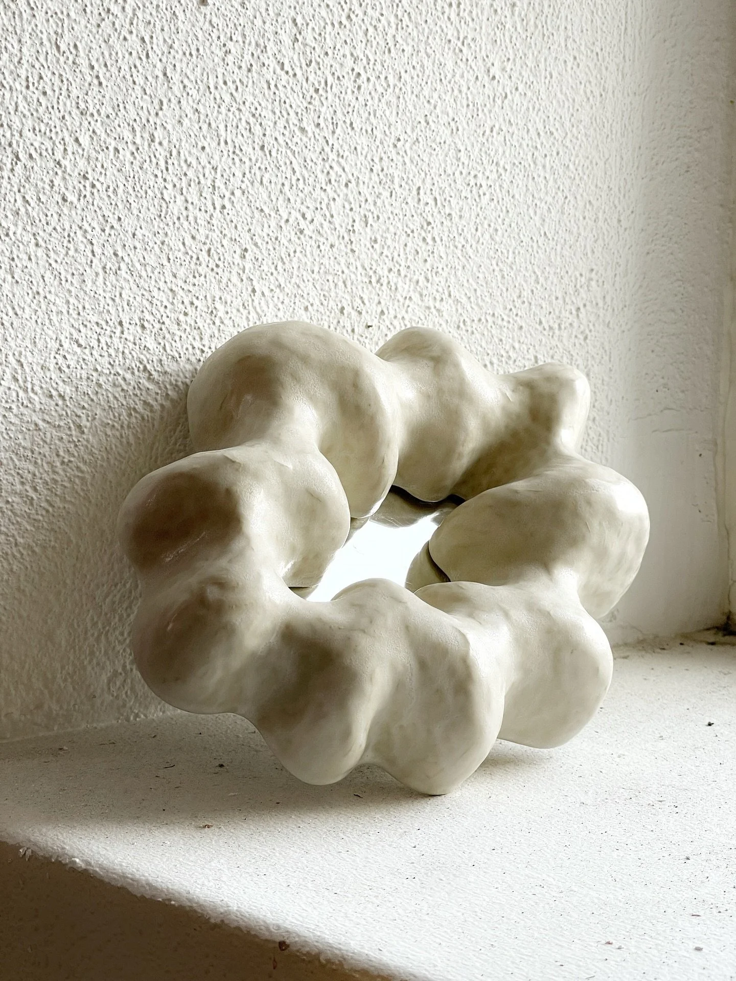 Sculpture with a small mirror inside, handmade in a bone white stoneware clay glazed with a semi matte white glaze🪞