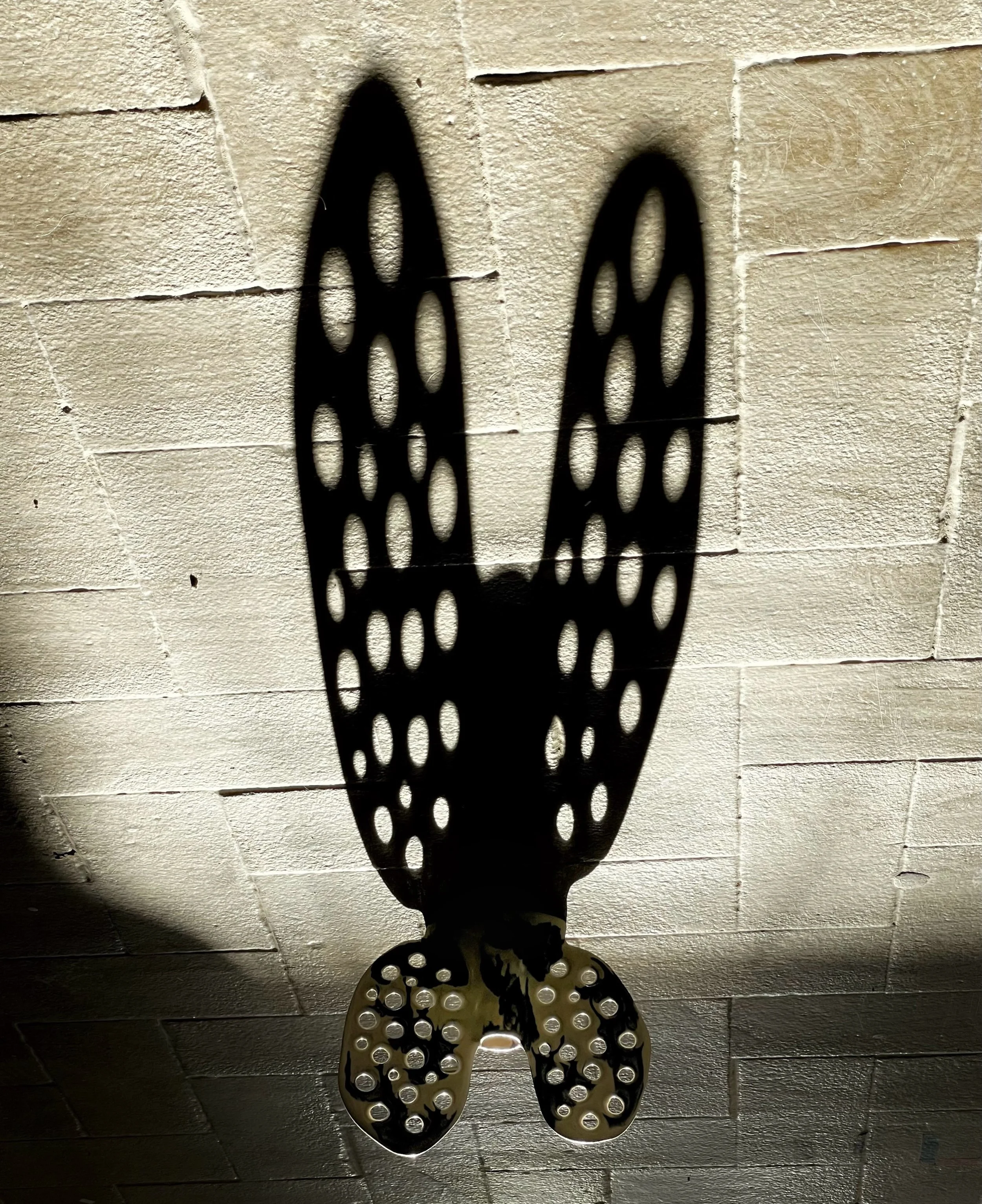 Candleholder with big ears casting a long shadow in the low sunlight 🕯️