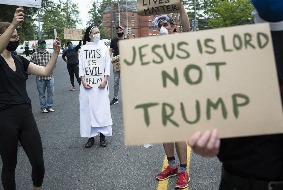 Catholic activists protest Trump's visit to St. John Paul II Shrine