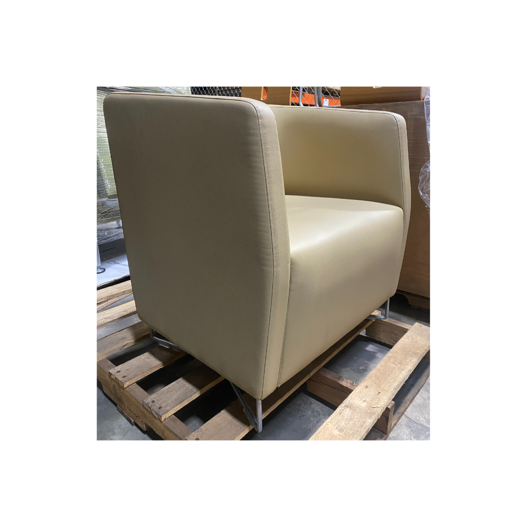 Contemporary Keilhauer Cahoots lounge chair featuring smooth beige upholstery and square armrest profile.