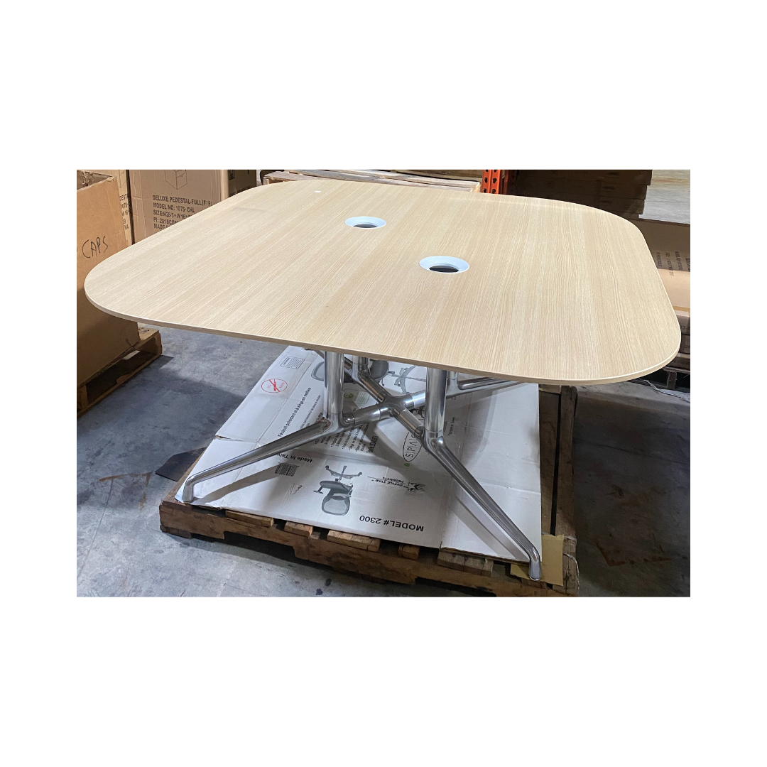 Coalesse collaboration table with beveled wood top and two white grommets, supported by X-shaped aluminum legs