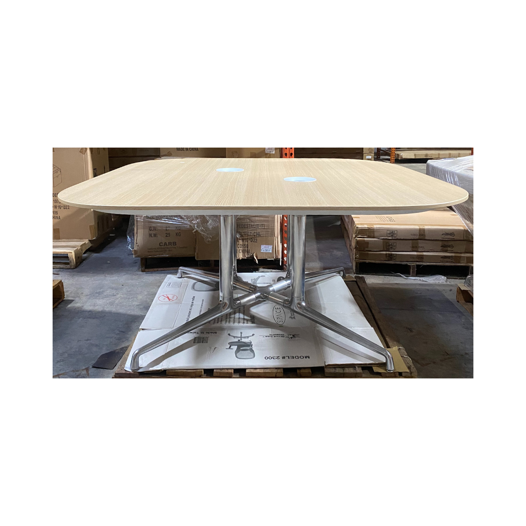 Light wood Coalesse conference table with rounded corners, dual grommet holes, and polished aluminum base