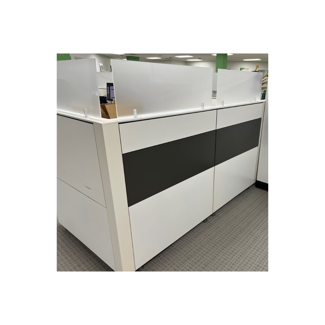 Modern office cubicle workstation with frosted acrylic privacy panels