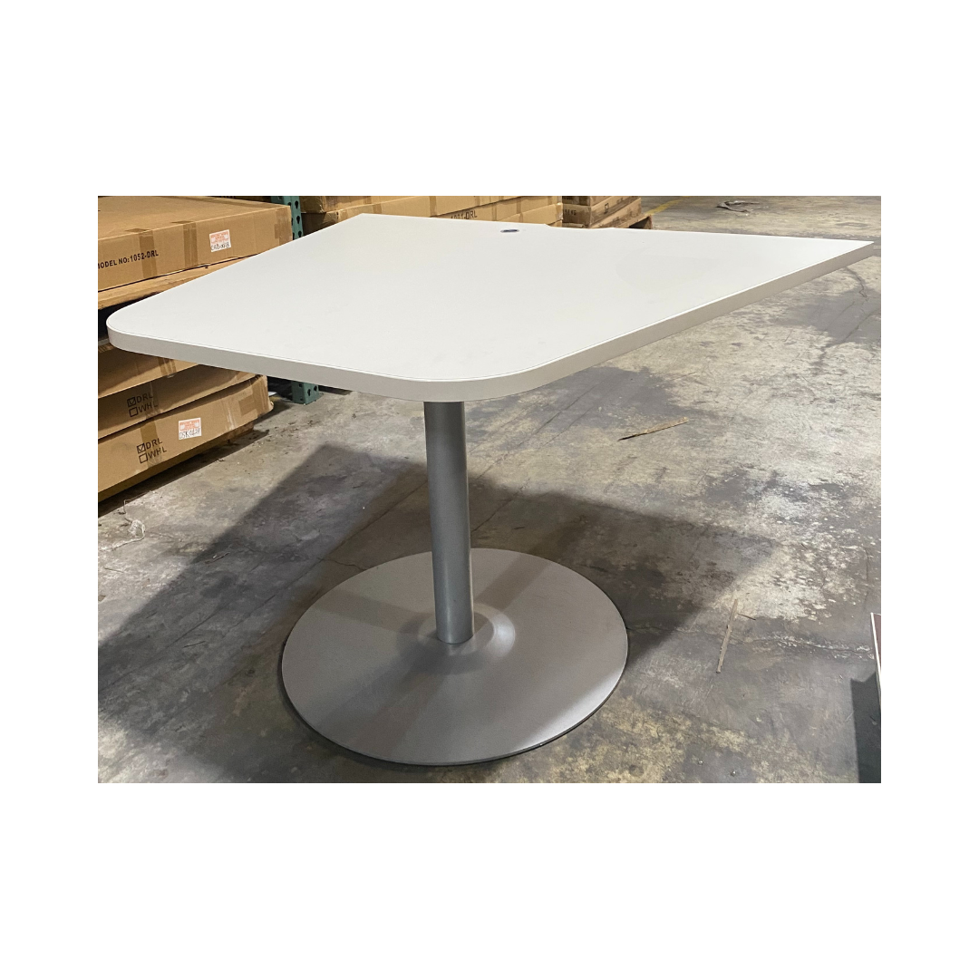 Modern white laminate table featuring a small cable grommet and a rounded pedestal base