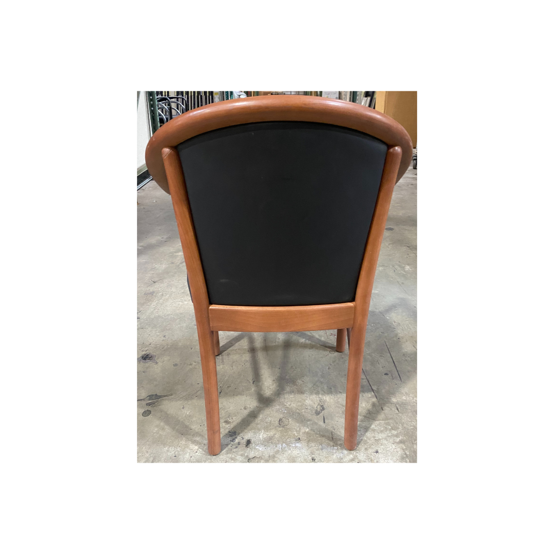 Wooden office guest chair by Steelcase with sculpted arms and black padded seat and backrest