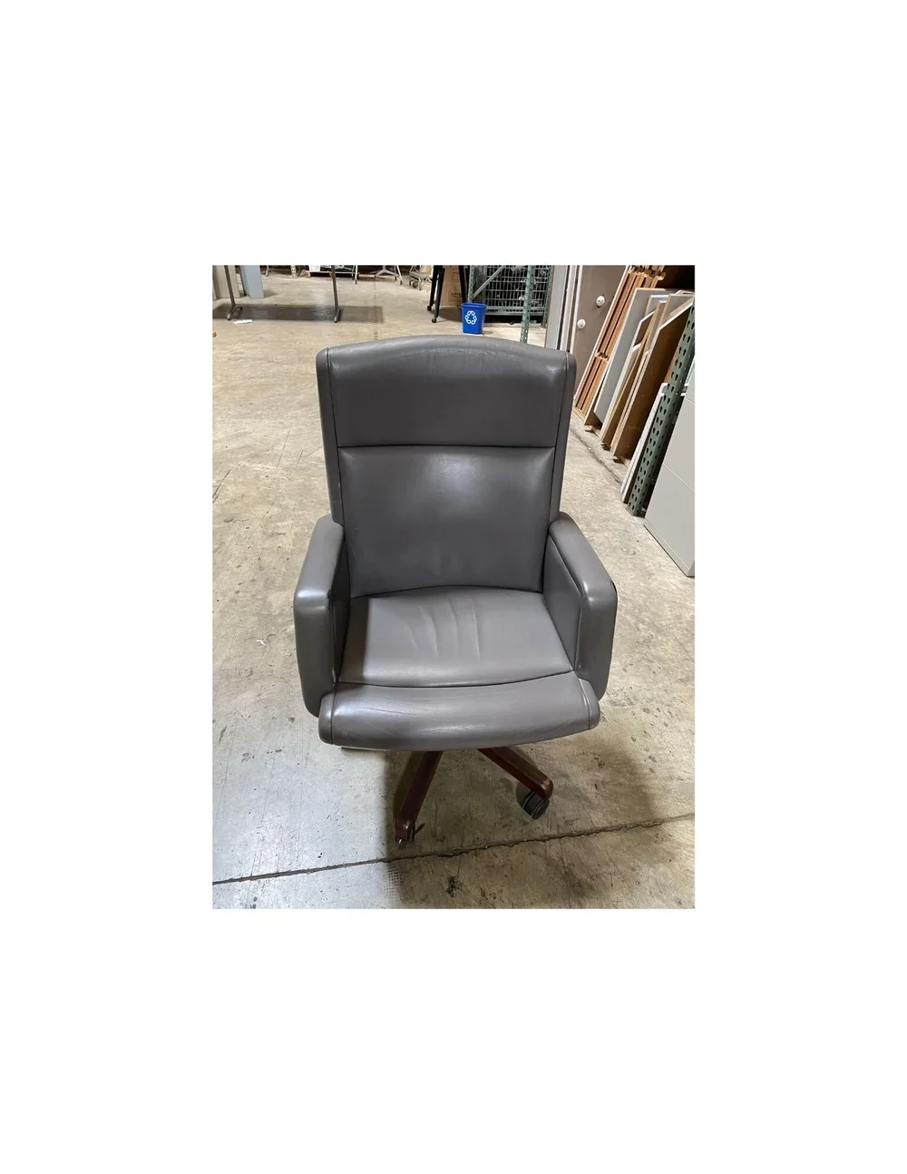 Vintage Stow and Davis gray leather rolling chair with wood veneer base and casters, available in Raleigh, NC