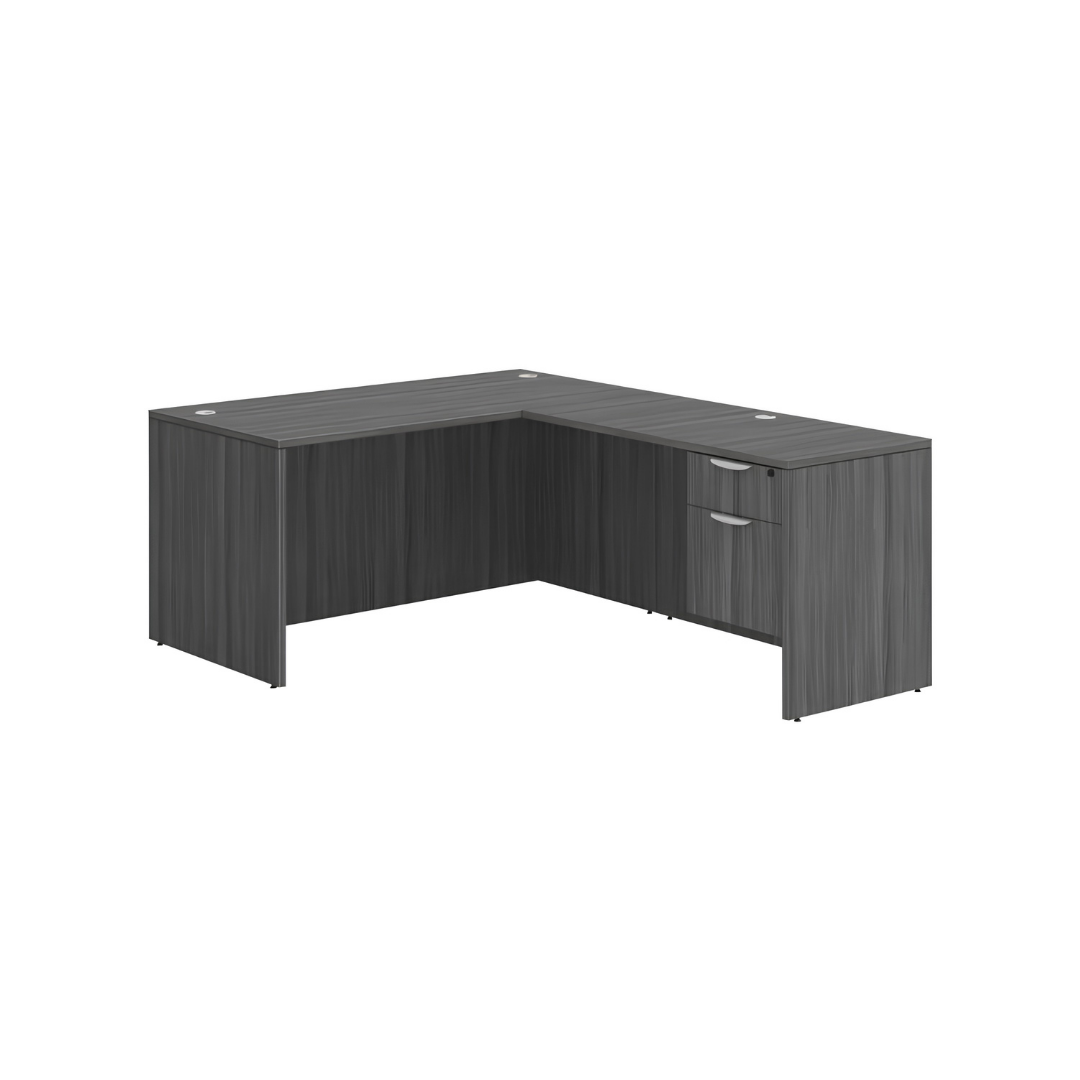Modern gray laminate L-shaped office desk with built in two drawer pedestal and cable management grommets