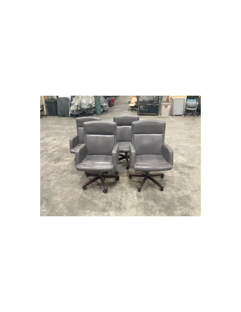 Preowned mid-century style Stow and Davis leather desk chair with casters and high-back support