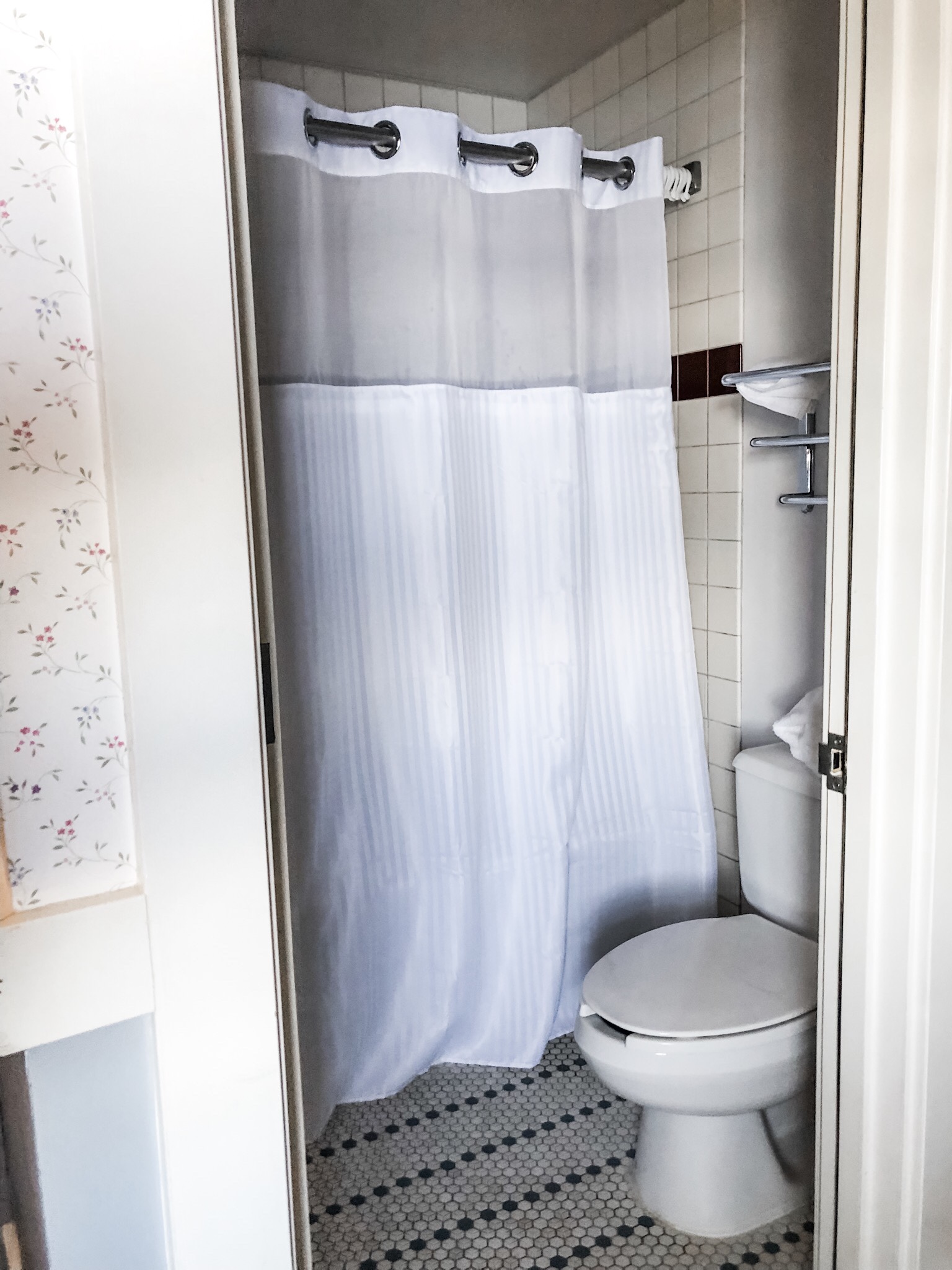 Bathroom with toilet and shower (with curtain). This isn’t a Four Seasons, but it’s a step above camping!