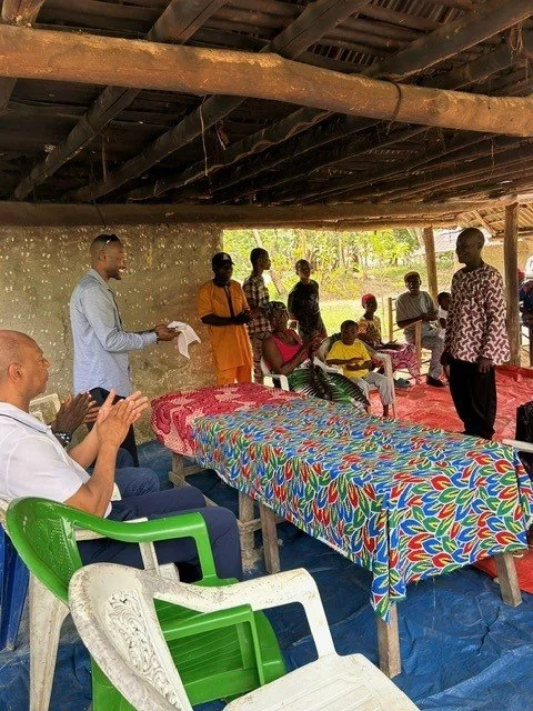 Pastor with men in hut.jpg
