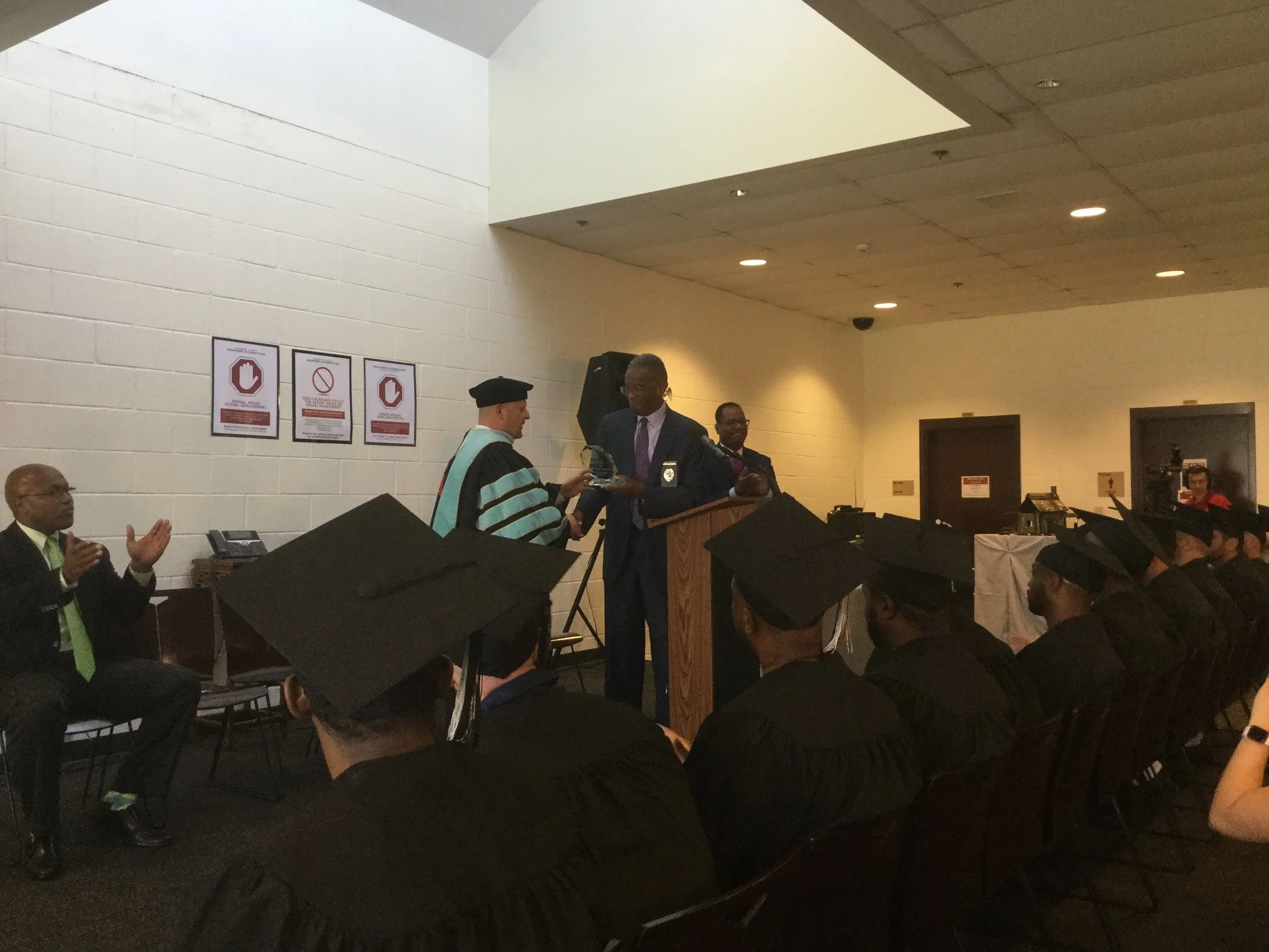 Gwinnett Correctional Warden and Gwinnett Technical College Dean distribute GEDs and awards to the graduating class.