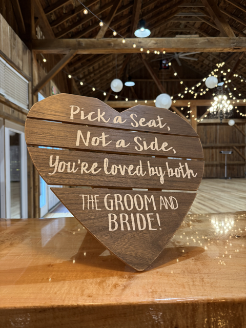 "Pick a seat not a side" Sign