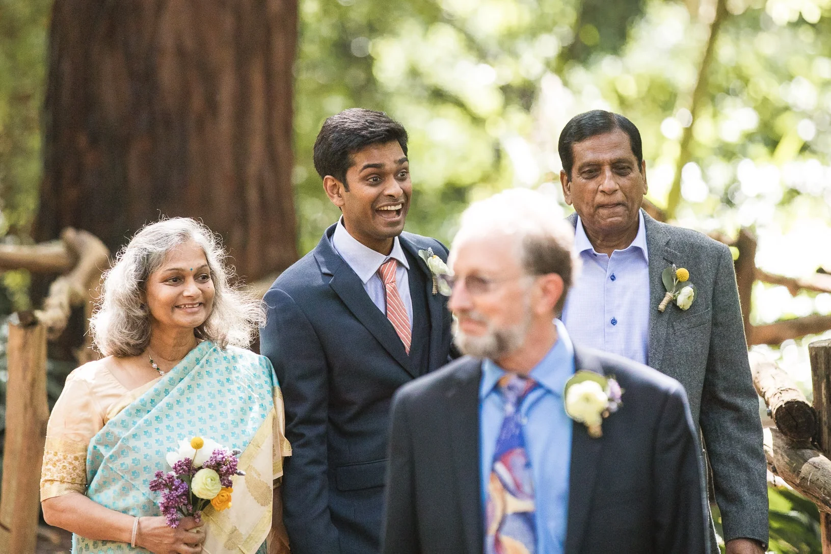You don’t always have to maintain your composure while walking down the aisle. Vikas, the groom, walks his parents down the aisle between the redwood tree, shows his excitement when he sees his family and friends.