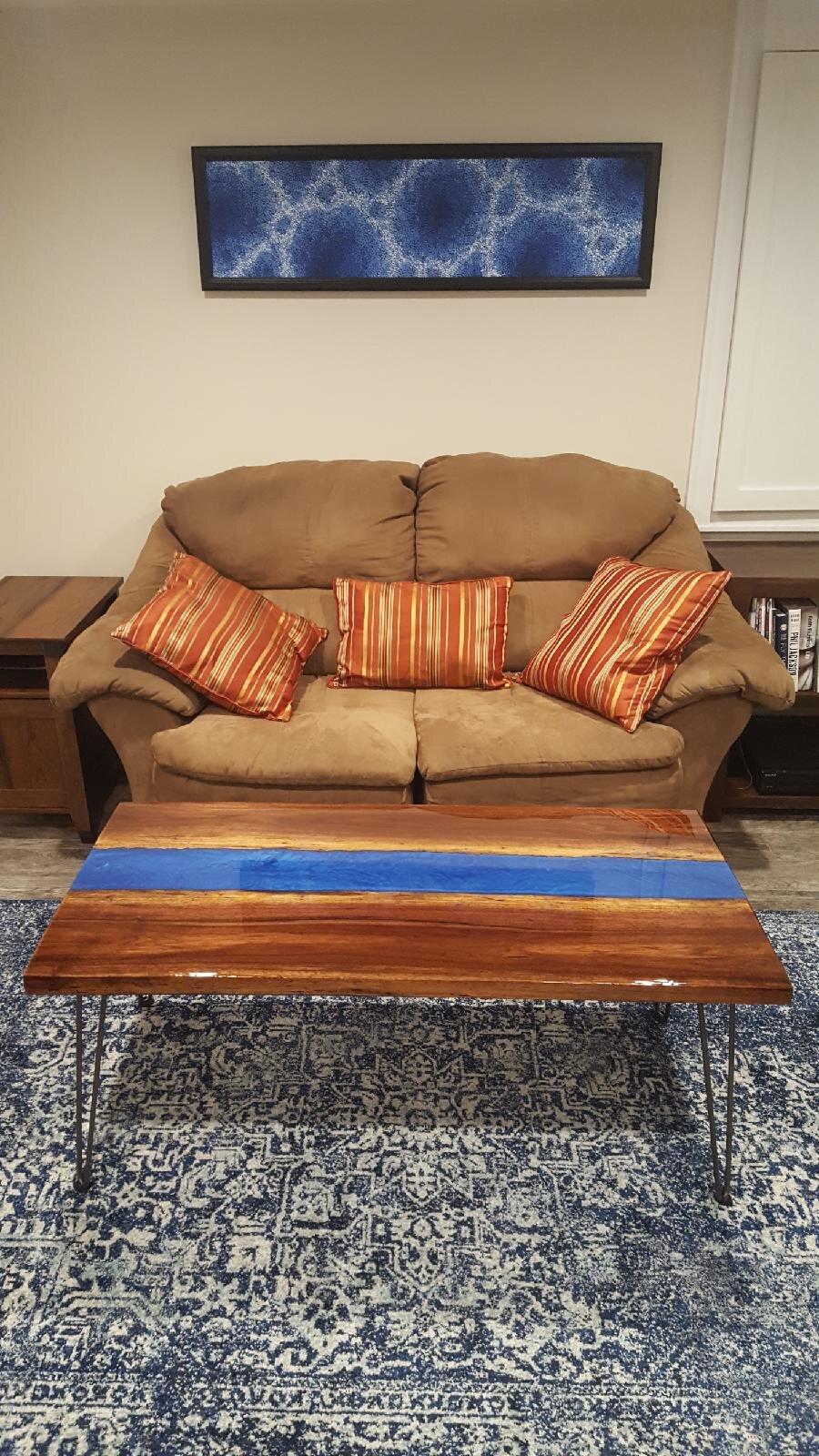 Black walnut blue river coffee table in a customer's living room