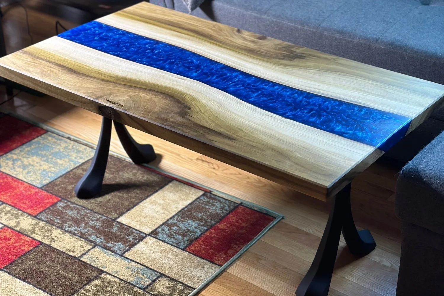 Blue epoxy river coffee table with natural wood grain