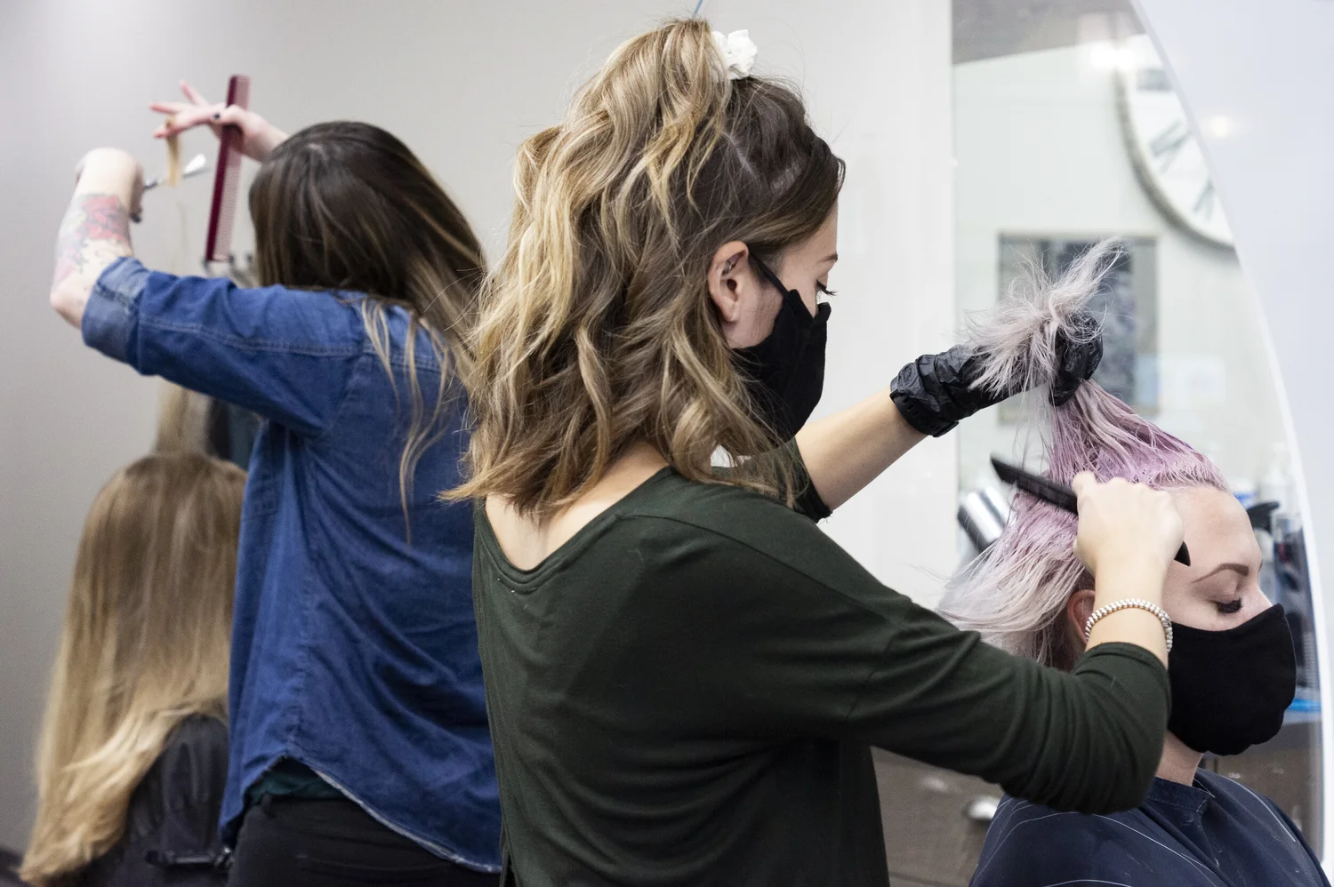 Members of the Theory Hair Studio team working with salon guests