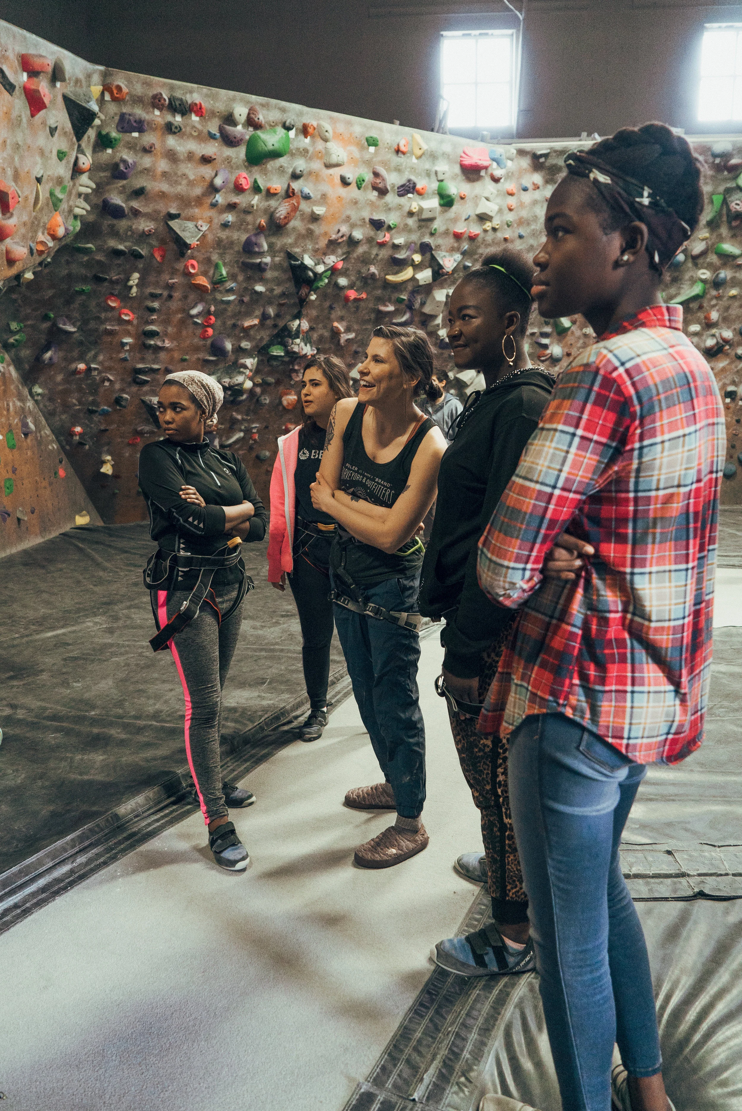 Dana explains how the bouldering area works, with color-coded tapes and no ropes needed.