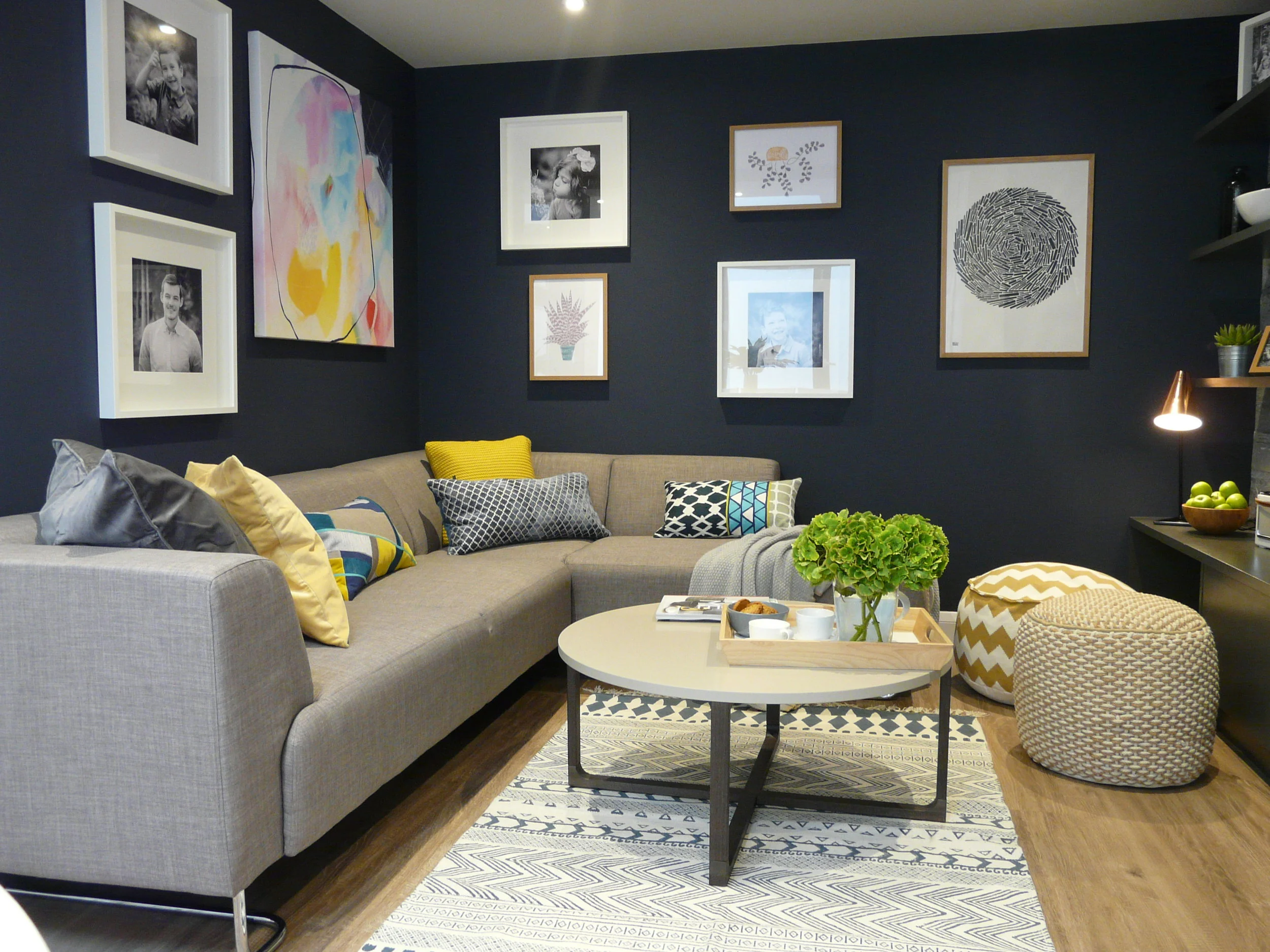 Dark navy cosy living room with geometric patterned soft furnishings