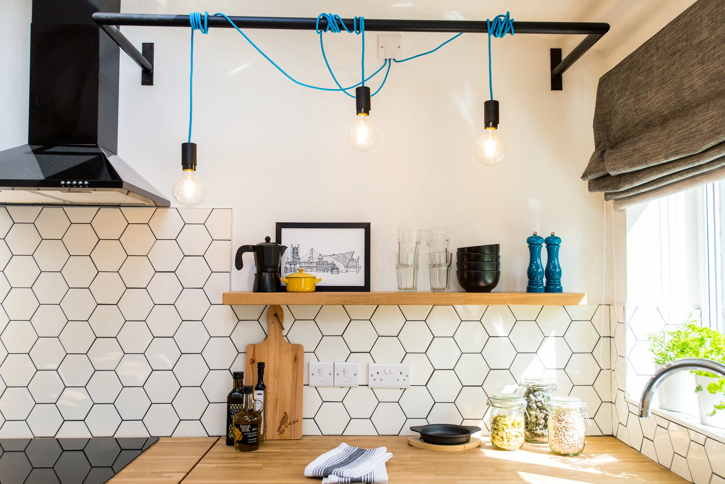 Kitchen with oak worktop and industrial lighting