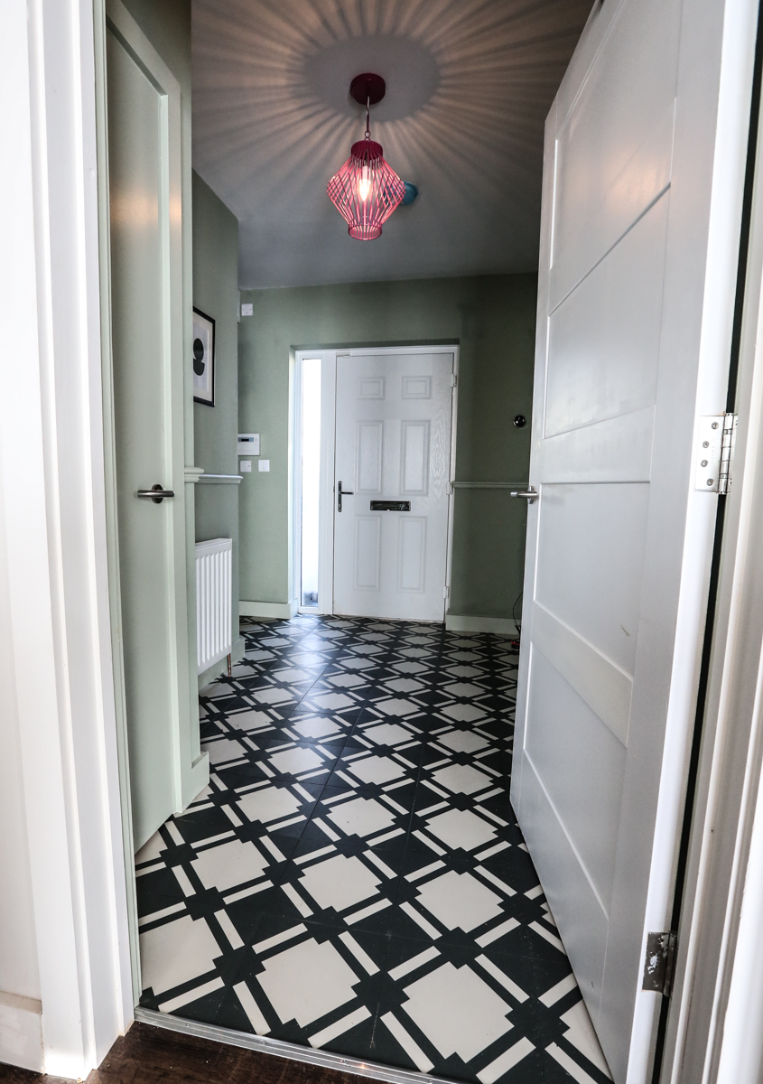 Hallway with a contrasting Neisha Crosland flooring in black and white.
