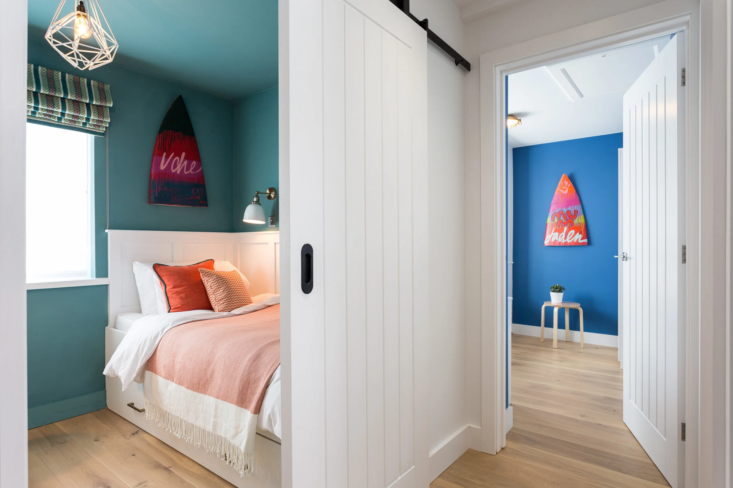 Bedroom with a panelled door on a black sliding door mechanism