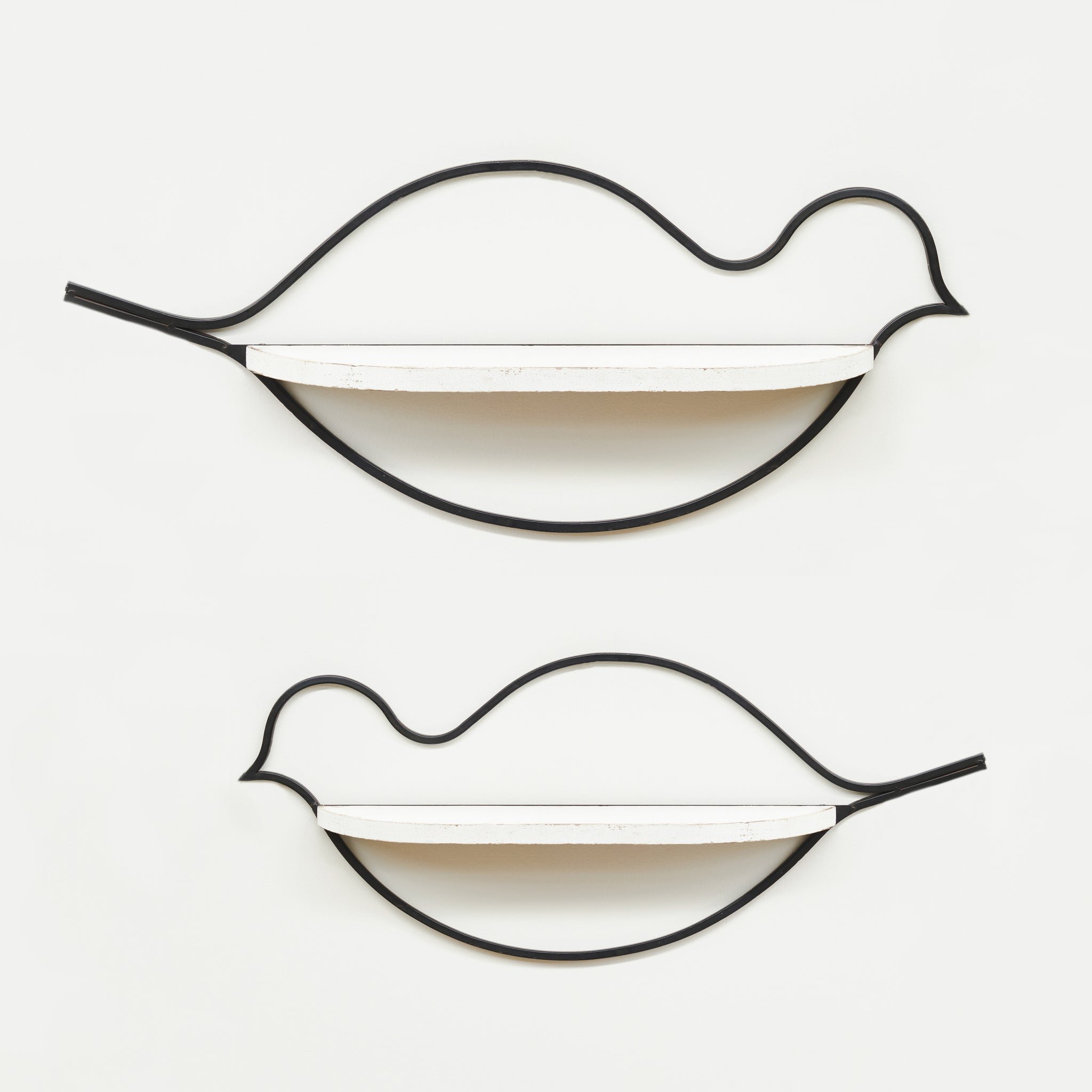 Black wire bird shape with white shelf in the middle