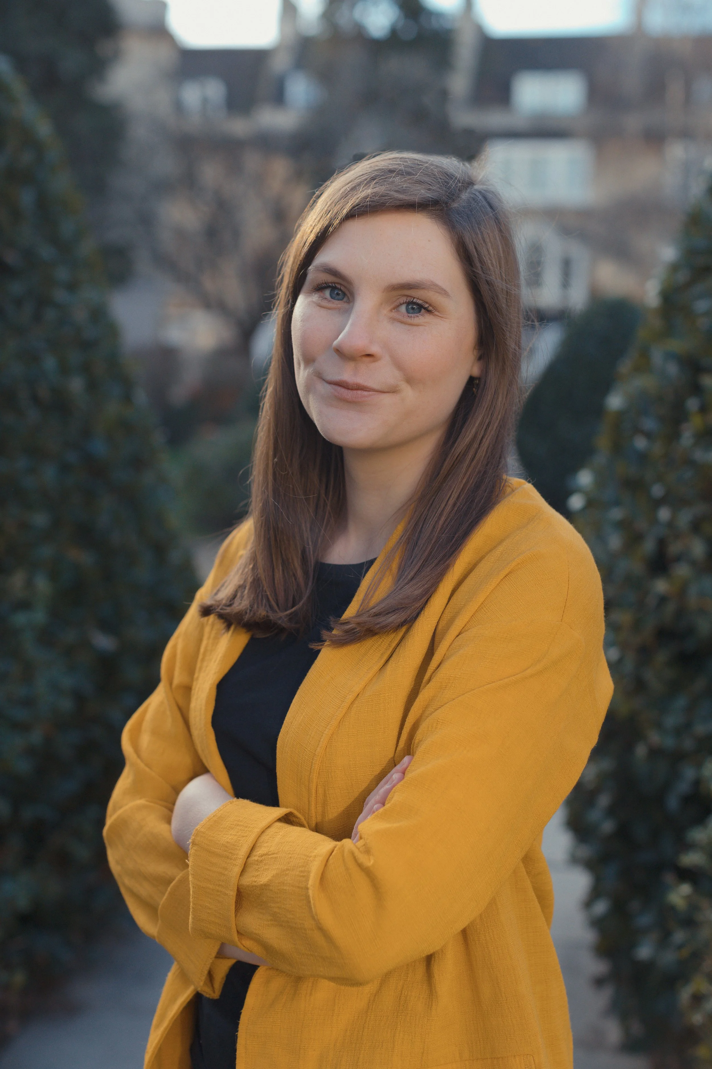 Interior designer Stephanie Williams wearing a yellow jacket and black top