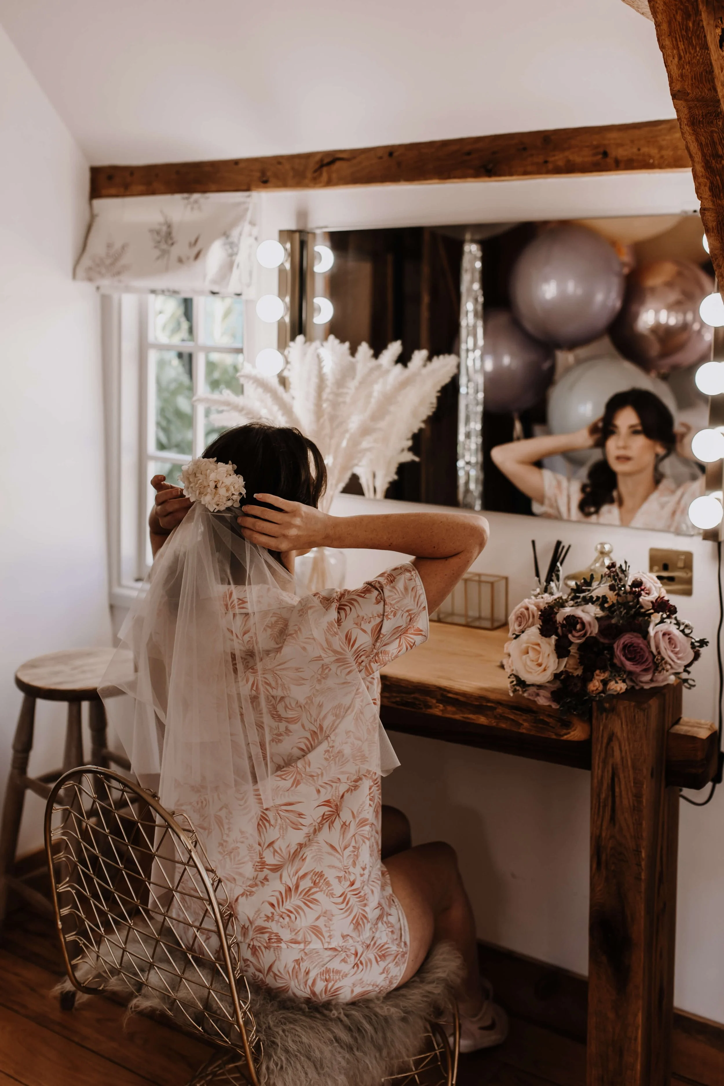 bride in wedding pjs veil mirror bridal make up