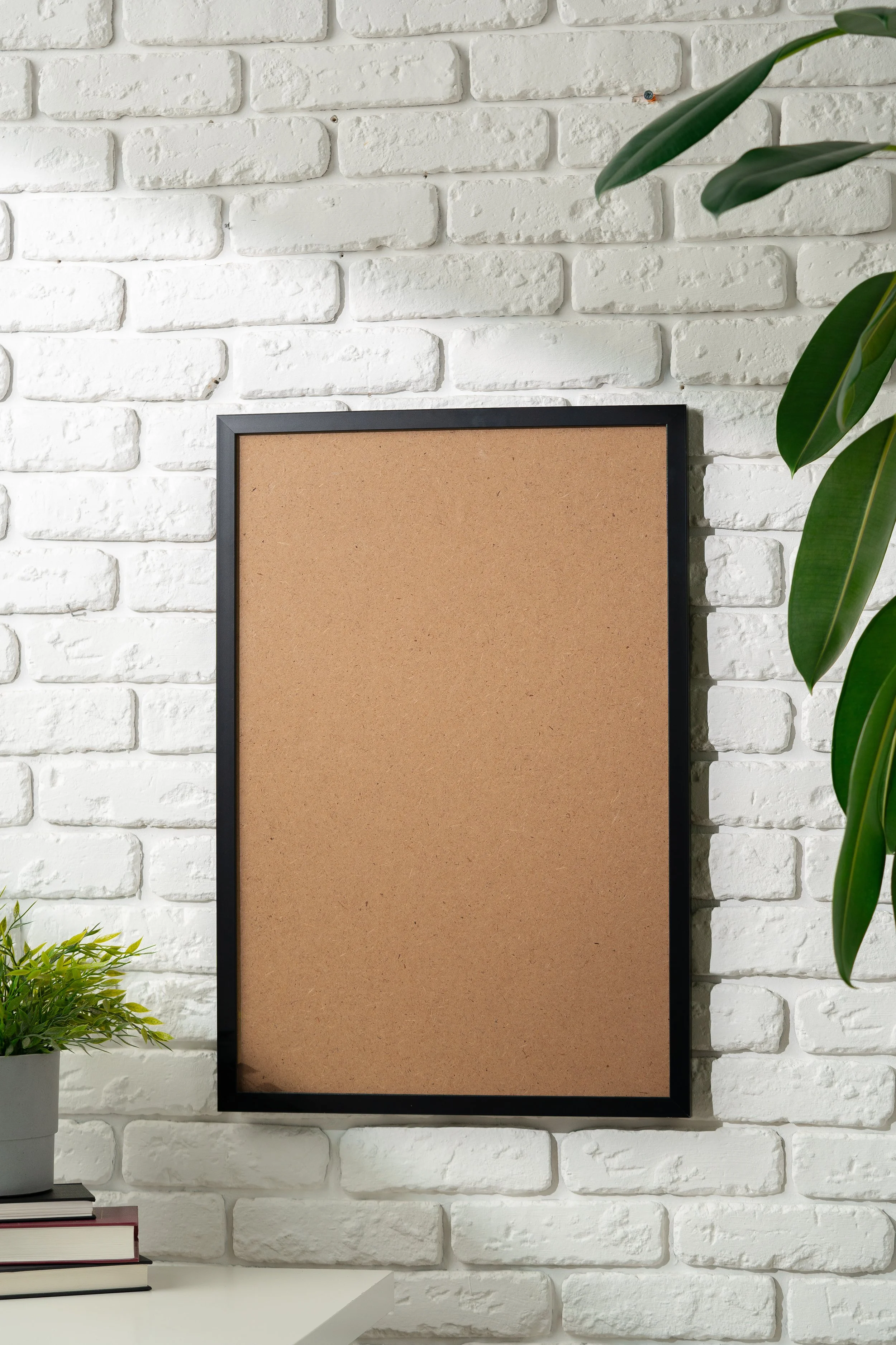 an 18 x 24 blank poster frame against a white brick wall.