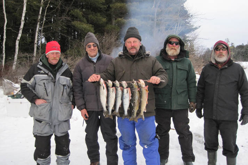 THE GANG WITH THEIR CATCHES ON THE ANNUAL ICE FISHING TRIP