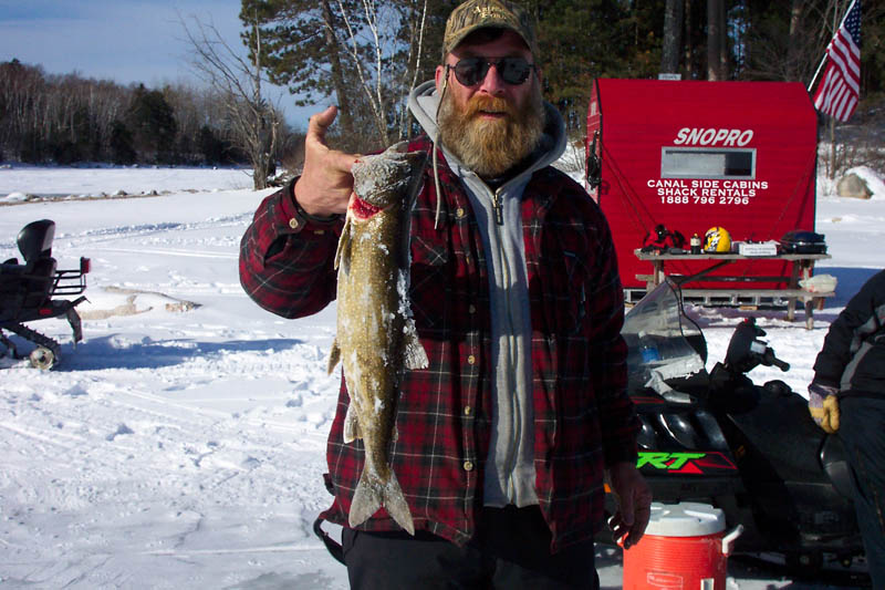 MARK STEWART WITH HIS BIG CATCH ON THE ANNUAL ICE FISHING TRIP