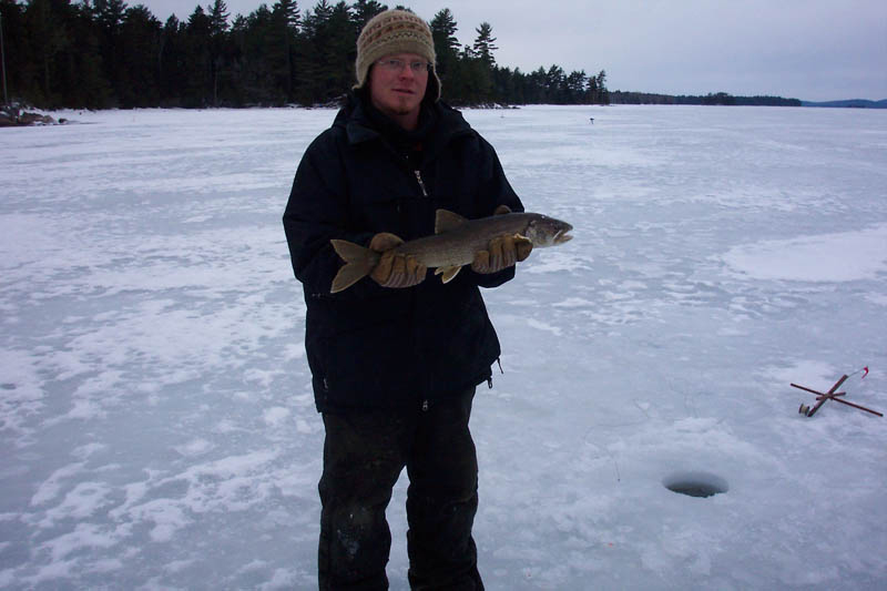 TOM WOOLDRIDGE WITH HIS BIG CATCH ON THE ANNUAL BREX CORP. ICE FISHING TRIP