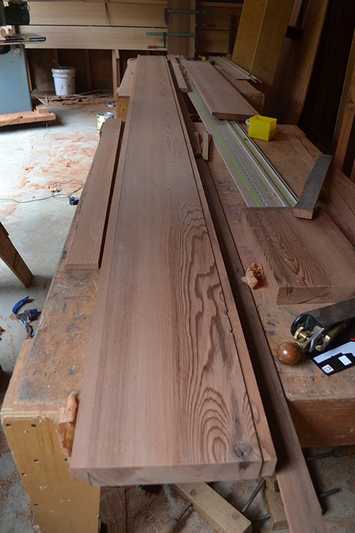 An early 20th-century redwood beam, rare for its size (10" x 10" x 16 feet), was milled into thick planks that will form the doorway envelope. 
