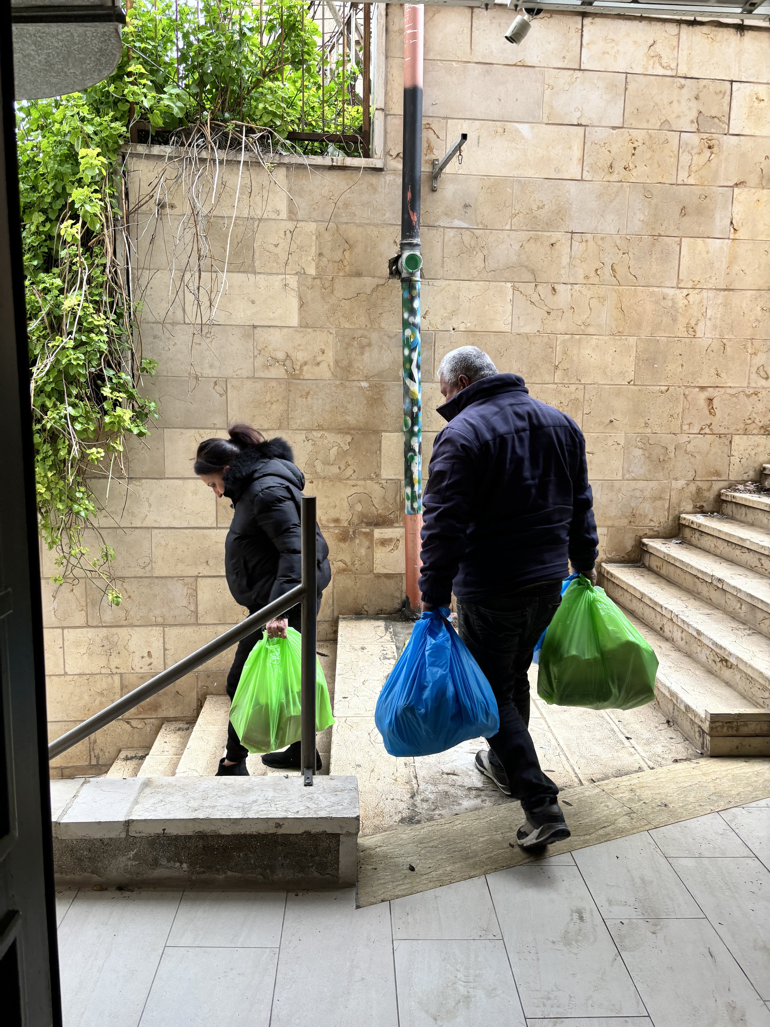 A couple collecting a relief parcel for their family.JPG