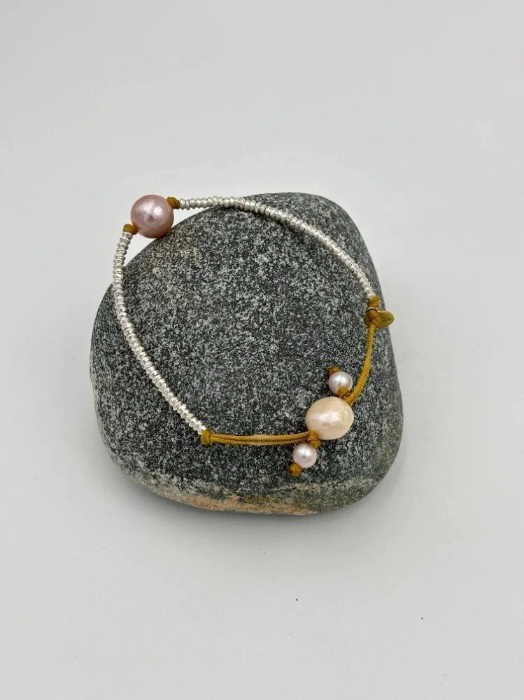 silver+and+pink+round+pearl+on+rock.jpg