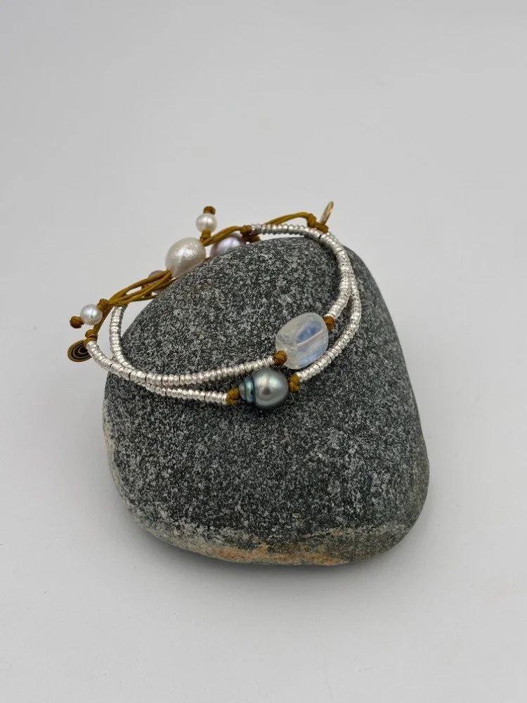 silver & moonstone and silver and grey pearl on rock.jpg